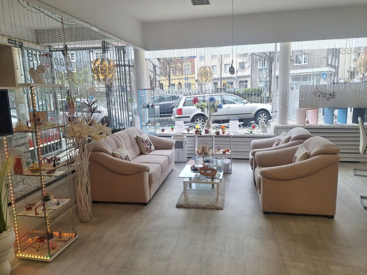 Gemütliche Sitzecke mit Sofa und Sesseln am großen Schaufenster